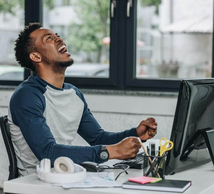 Black man staring at the laptop